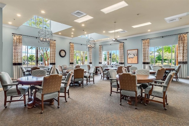 dining space featuring an inviting chandelier, ornamental molding, and carpet