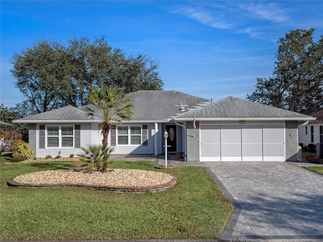 ranch-style house featuring a garage and a front yard