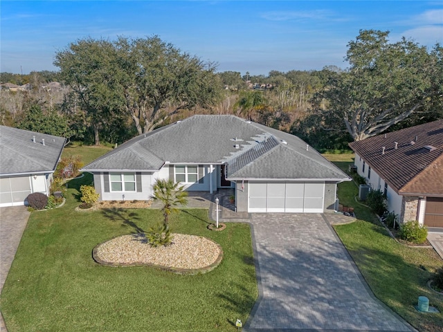 view of front of property featuring a garage and a front yard