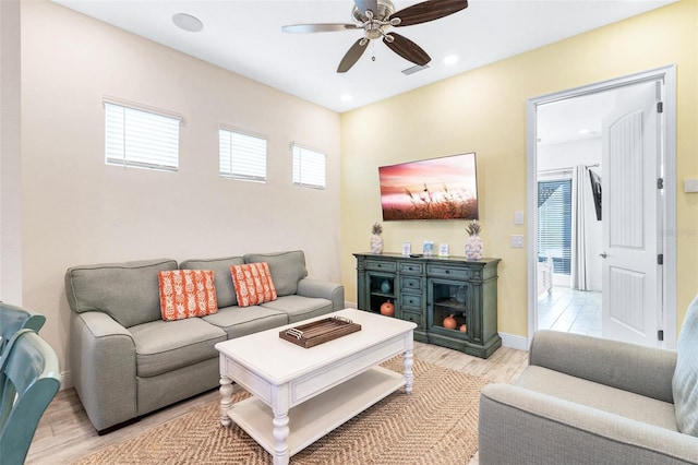 living room with ceiling fan and light wood-type flooring