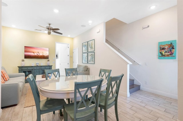 dining space featuring ceiling fan and light hardwood / wood-style floors