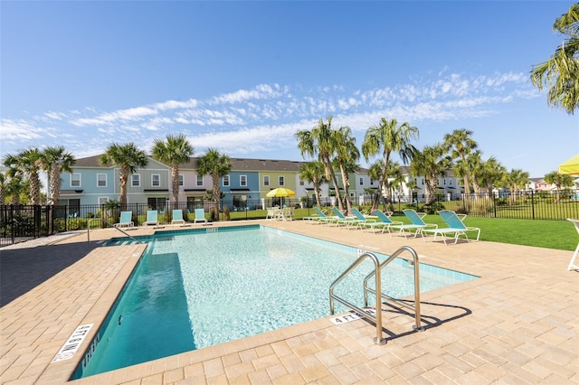 view of swimming pool featuring a patio and a lawn