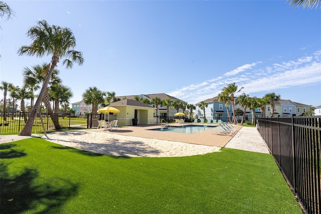 view of swimming pool featuring a lawn and a patio area