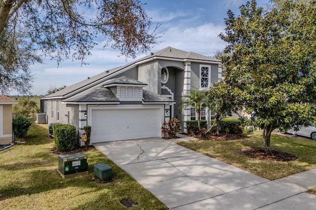 view of front facade featuring cooling unit, a garage, and a front yard