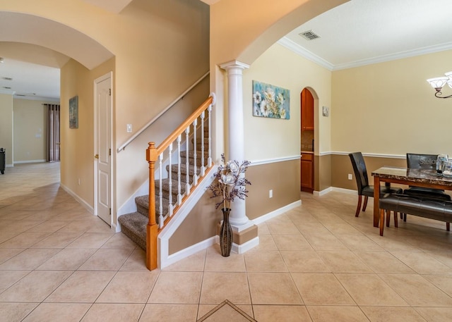 staircase with ornamental molding and tile patterned flooring