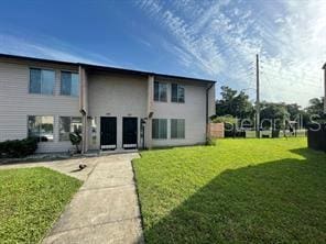 rear view of house featuring a lawn