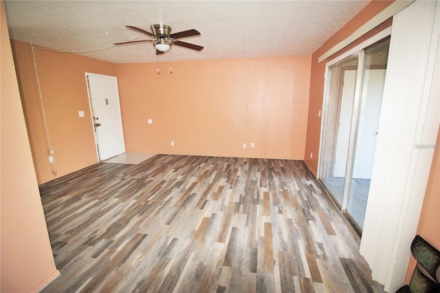 unfurnished living room with hardwood / wood-style flooring, ceiling fan, and a textured ceiling