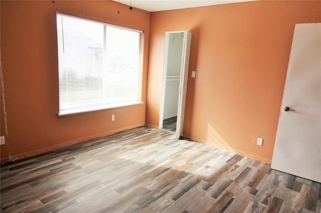 unfurnished bedroom featuring hardwood / wood-style flooring