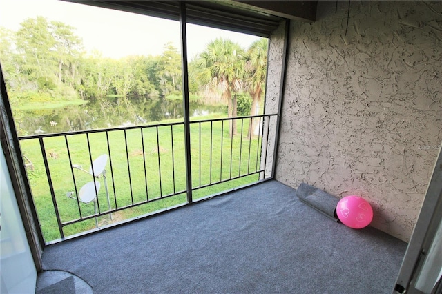 unfurnished sunroom with a water view