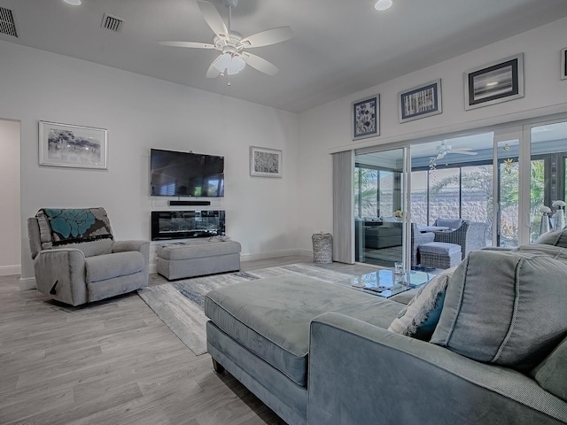 living room with hardwood / wood-style flooring and ceiling fan