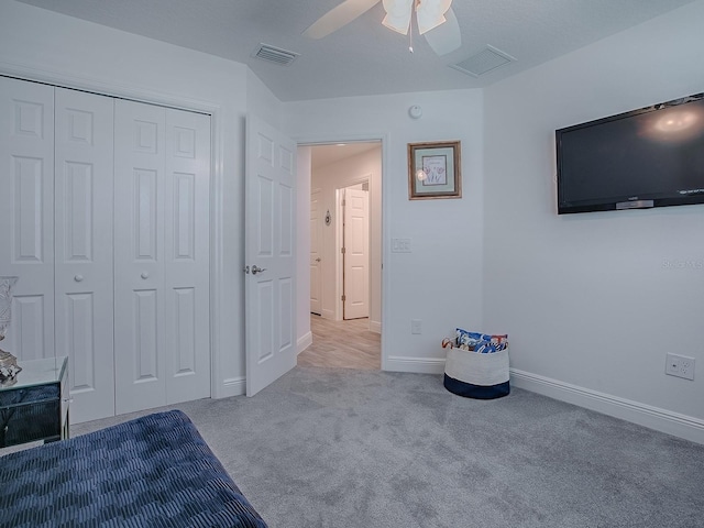 unfurnished bedroom with light carpet, a closet, and ceiling fan