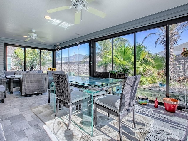 sunroom / solarium featuring ceiling fan and a mountain view