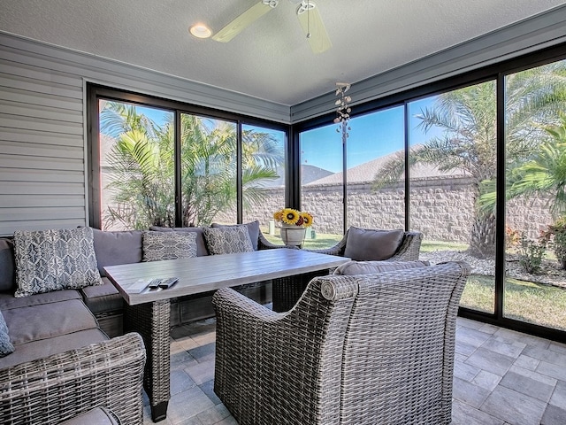 sunroom featuring breakfast area and ceiling fan