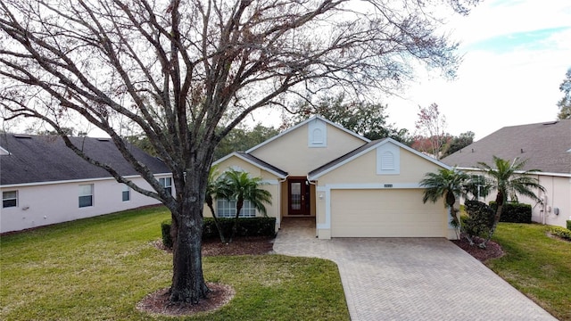 view of front of house featuring a garage and a front lawn