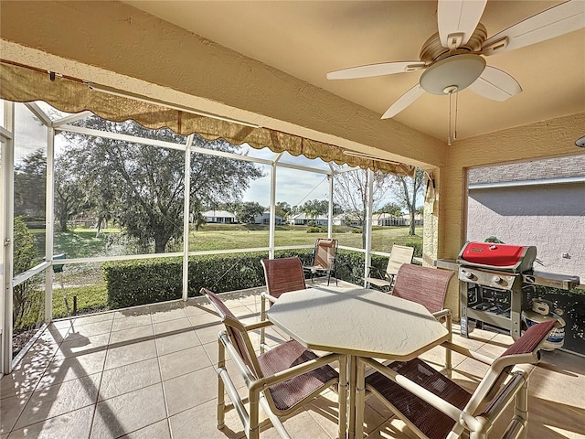 sunroom featuring ceiling fan and vaulted ceiling