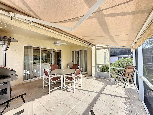 sunroom with beamed ceiling and ceiling fan