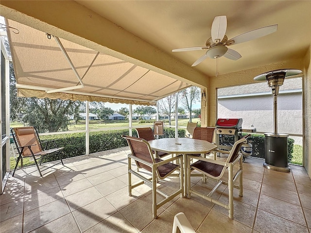 sunroom featuring ceiling fan