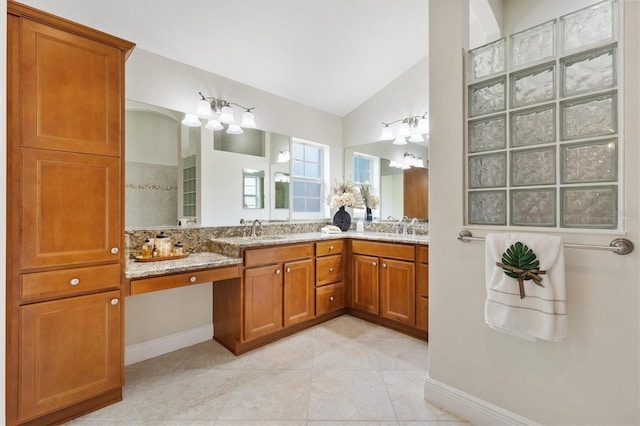 bathroom featuring vanity, lofted ceiling, and tile patterned floors