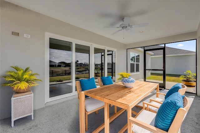 sunroom / solarium featuring ceiling fan