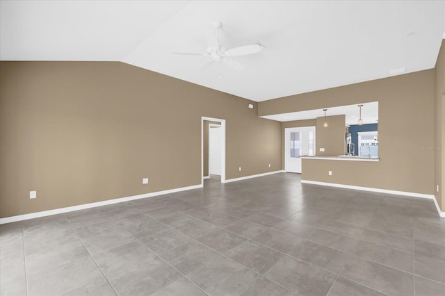 tiled empty room with vaulted ceiling and ceiling fan