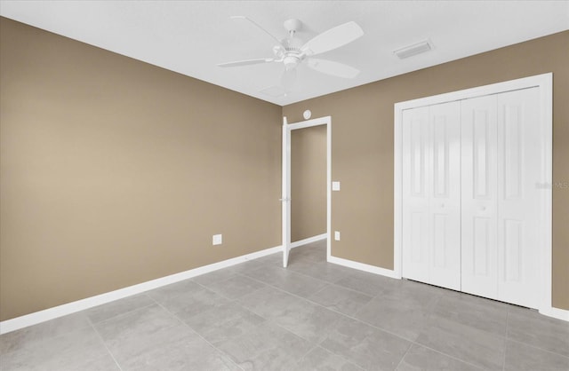 unfurnished bedroom featuring light tile patterned floors, ceiling fan, and a closet