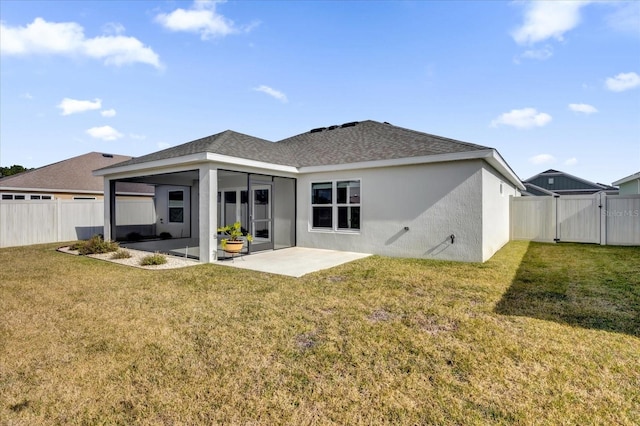 back of property featuring a yard and a patio area