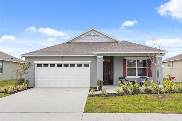 view of front of property with a garage, a front lawn, and a porch