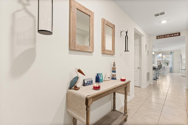 hall with light tile patterned floors