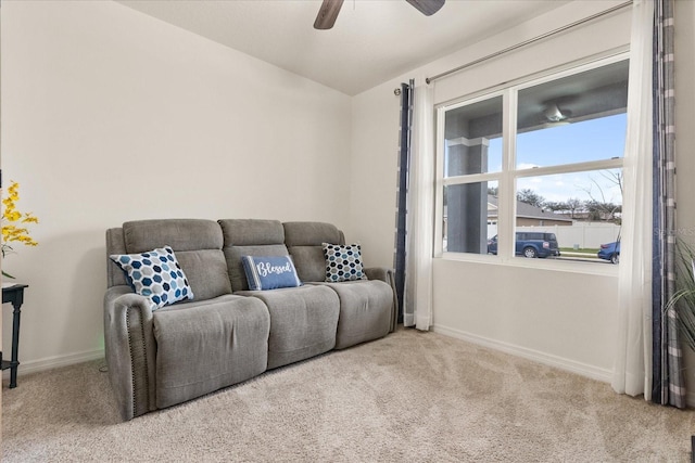 carpeted living room featuring vaulted ceiling and ceiling fan