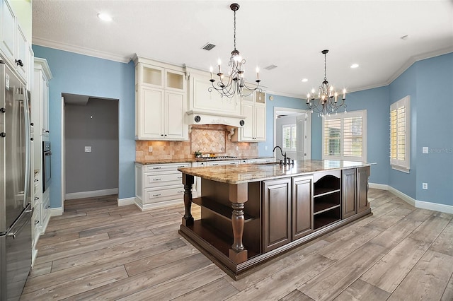 kitchen featuring stainless steel appliances, open shelves, decorative backsplash, and light wood-style flooring