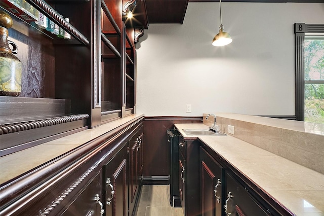 bar featuring a sink and decorative light fixtures