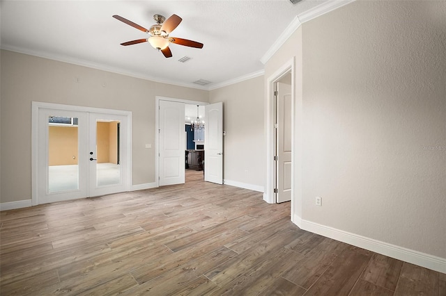 unfurnished bedroom with baseboards, visible vents, ornamental molding, wood finished floors, and french doors