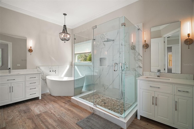 full bathroom featuring crown molding, a marble finish shower, a sink, and wood finished floors