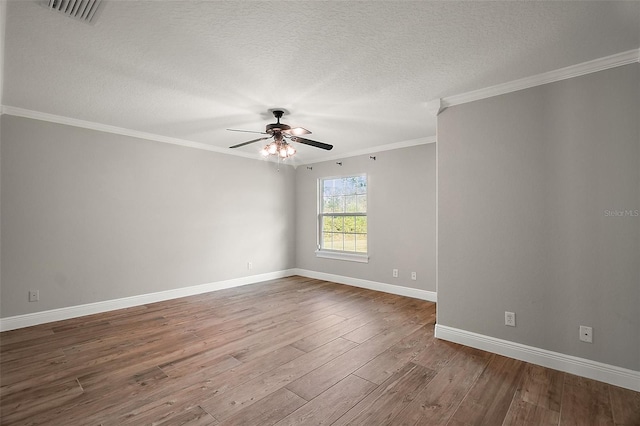 empty room featuring visible vents, ceiling fan, ornamental molding, wood finished floors, and a textured ceiling