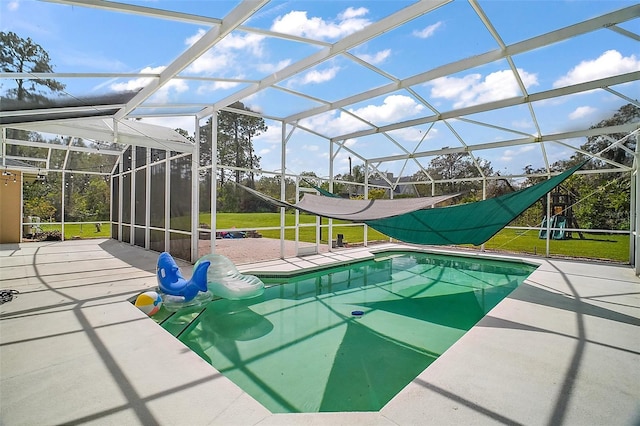 view of swimming pool featuring a fenced in pool, a lanai, a patio area, and a lawn