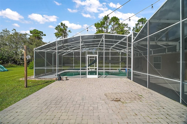 exterior space with glass enclosure and an outdoor pool