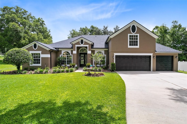 view of front of house featuring a garage and a front lawn