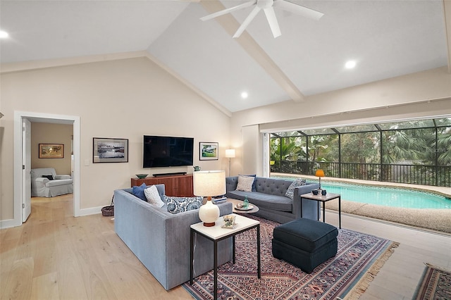 living room with lofted ceiling, ceiling fan, and light wood-type flooring