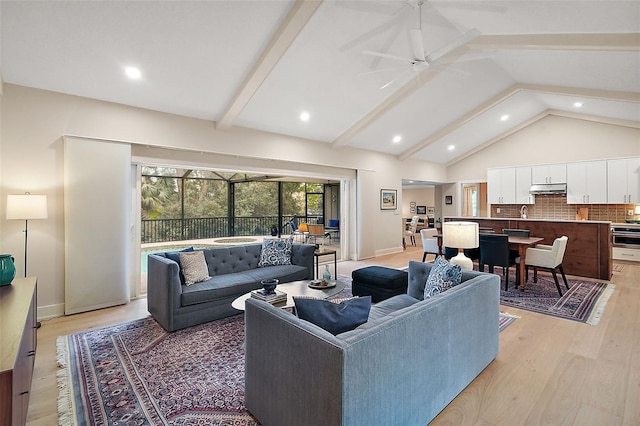 living room with beamed ceiling, high vaulted ceiling, ceiling fan, and light wood-type flooring