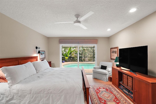 bedroom featuring ceiling fan, access to exterior, light hardwood / wood-style floors, and a textured ceiling