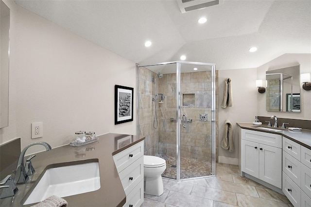 bathroom featuring tile patterned floors, lofted ceiling, toilet, vanity, and a shower with door