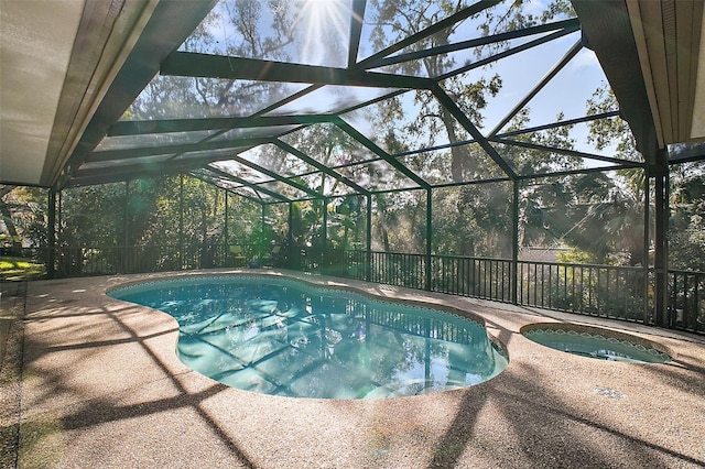 view of swimming pool featuring a patio area, an in ground hot tub, and glass enclosure