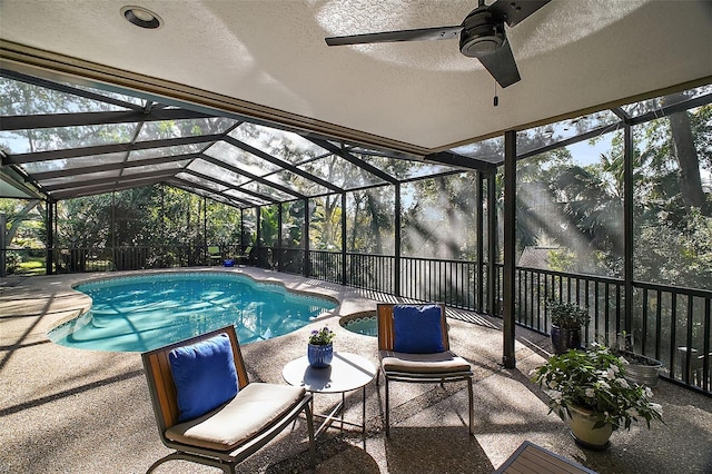 view of pool with a patio area and glass enclosure