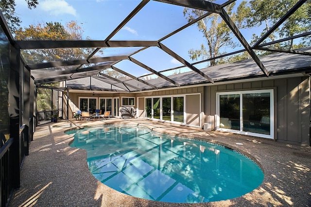 view of pool featuring a patio area and glass enclosure