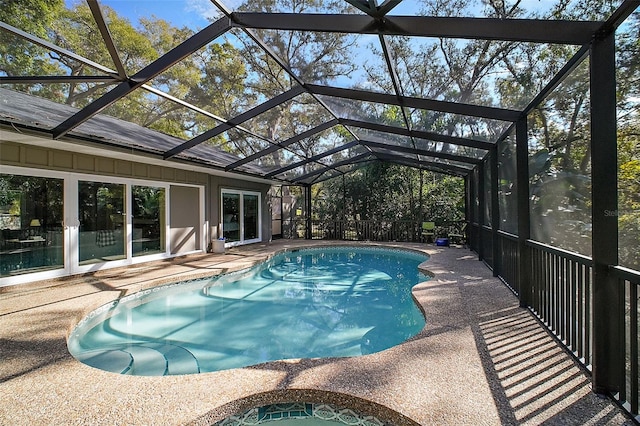 view of pool featuring a patio and glass enclosure