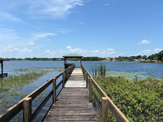 view of dock with a gazebo and a water view