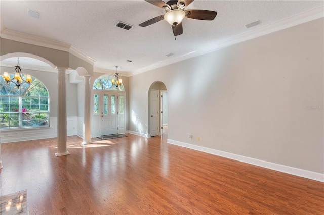 spare room with crown molding, light hardwood / wood-style flooring, a textured ceiling, and ornate columns