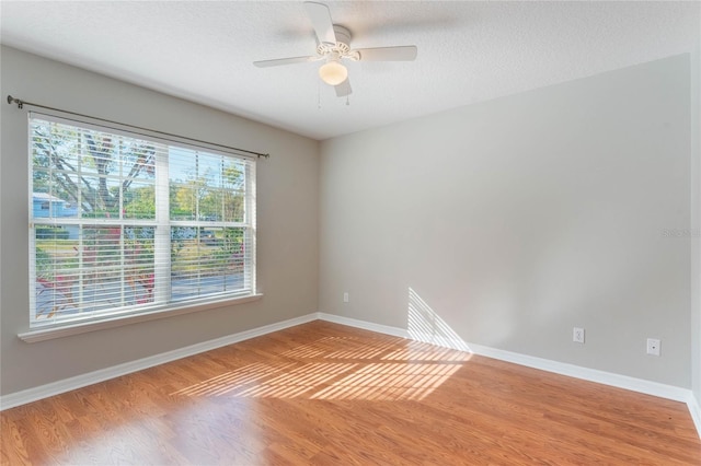 spare room with hardwood / wood-style flooring and ceiling fan