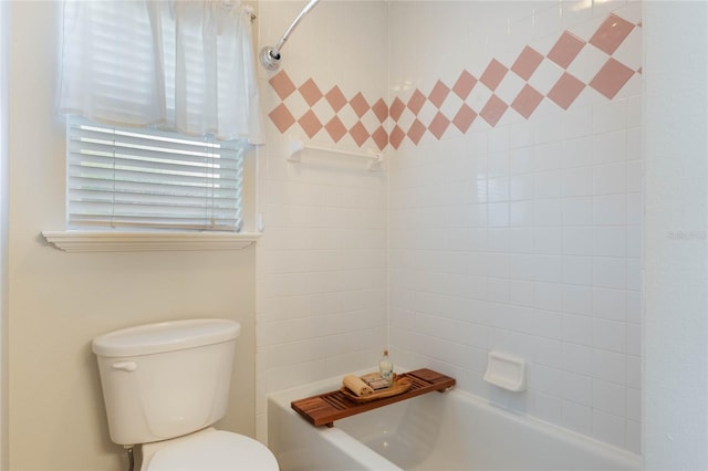 bathroom featuring toilet and tiled shower / bath combo