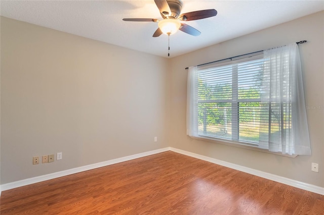 empty room with wood-type flooring and ceiling fan